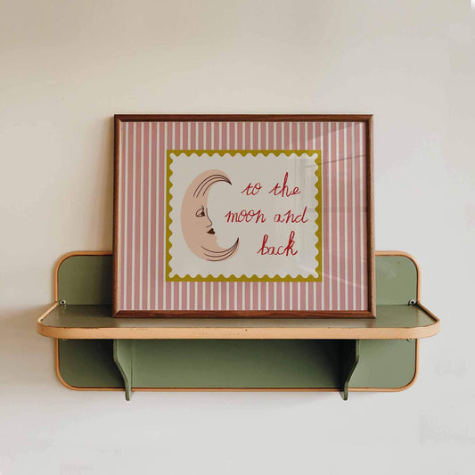 Framed artwork with 'to the moon and back' text on a striped background, displayed on a wall shelf.