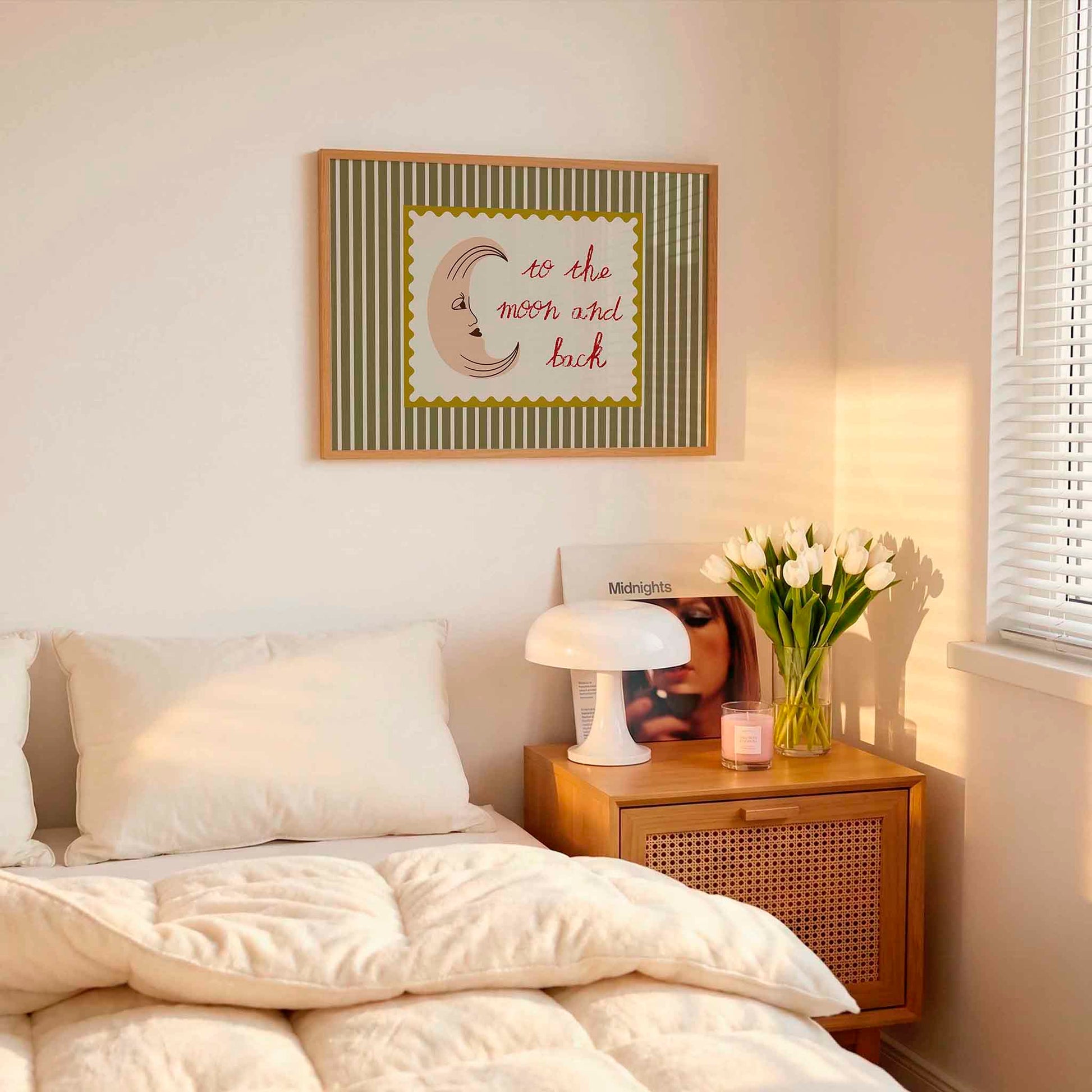 Bedroom with a bed, nightstand, lamp, and framed picture on the wall.