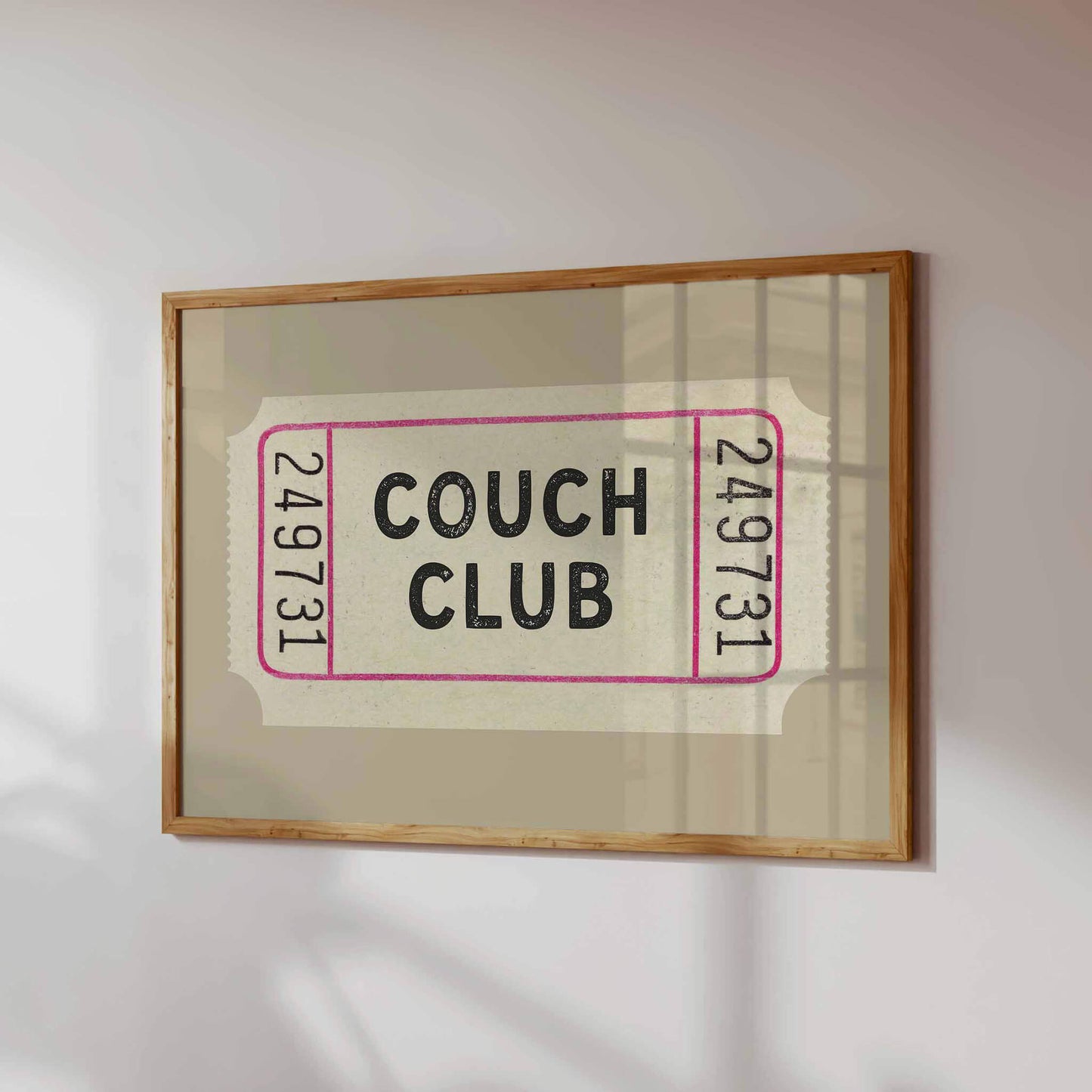 a framed poster with the text "Couch Club" on it.