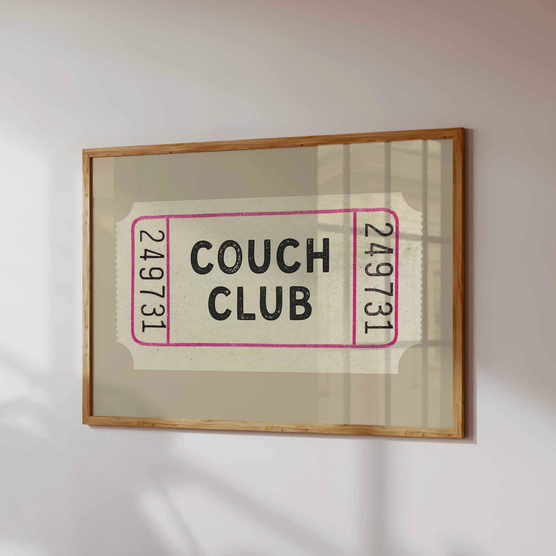 a framed poster with the text "Couch Club" on it.