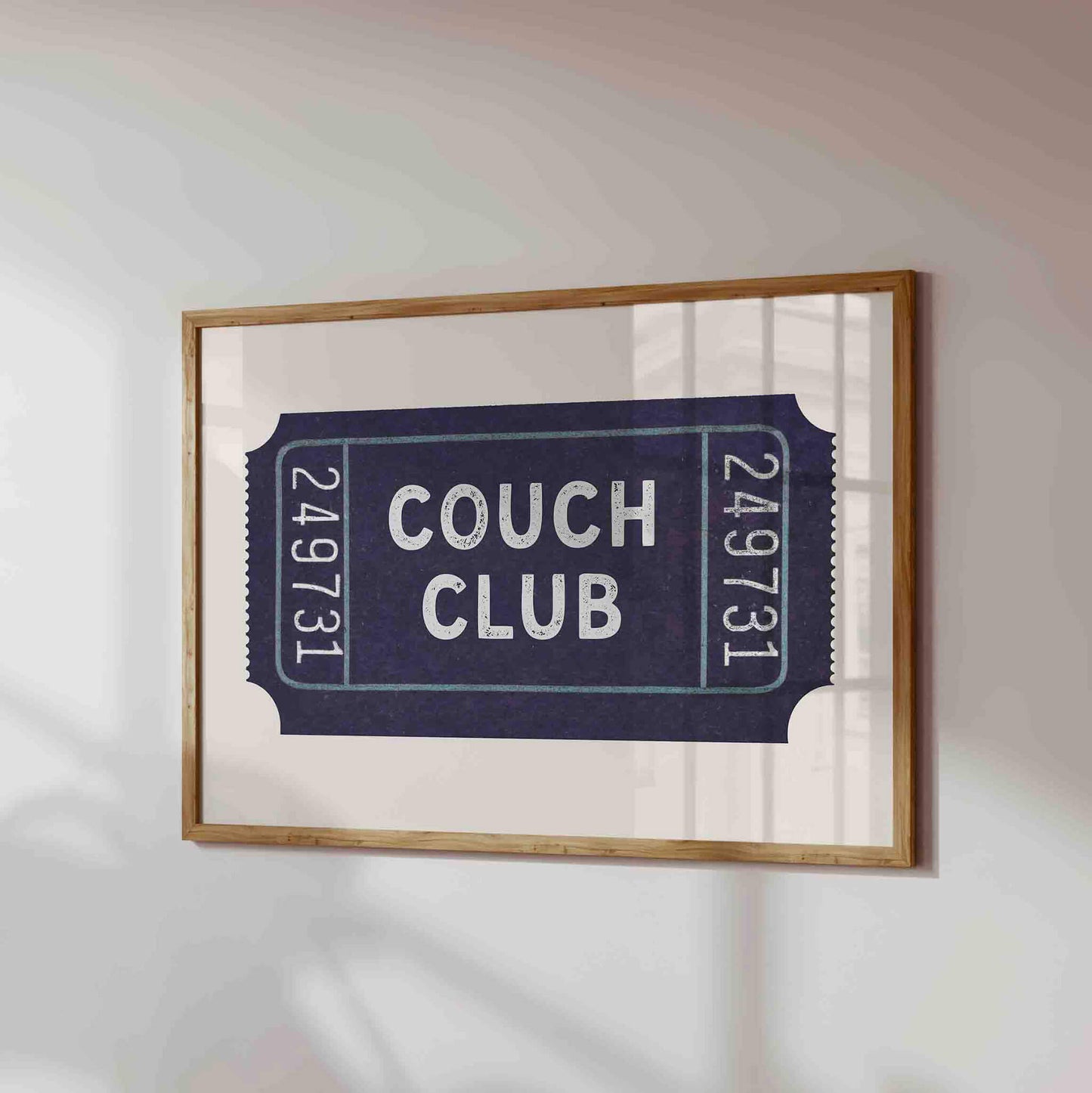 a framed poster or artwork with the text "Couch Club" on it.