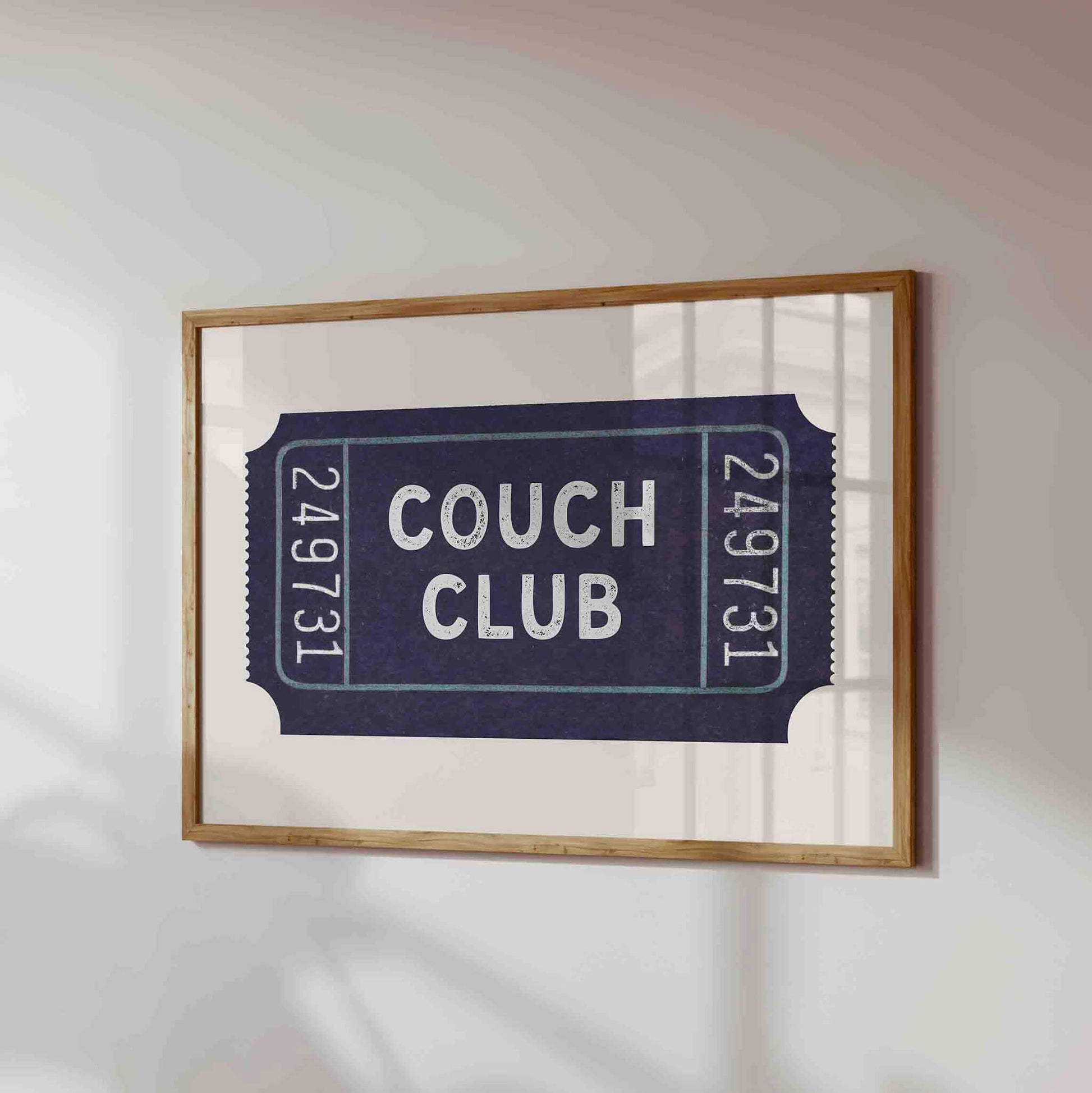 a framed poster or artwork with the text "Couch Club" on it.
