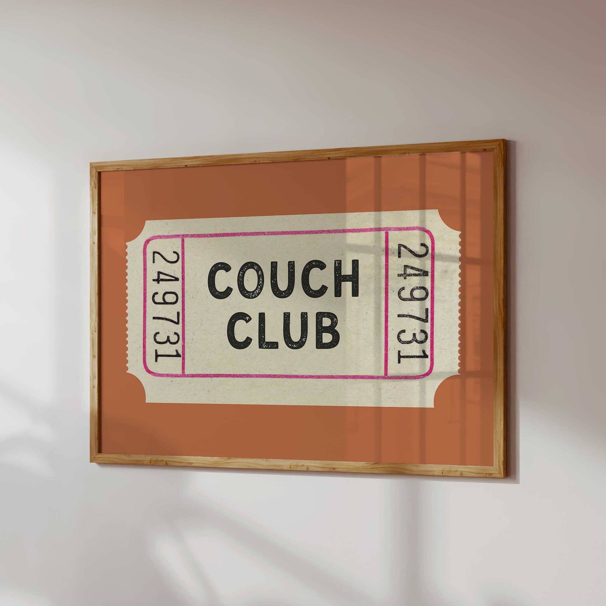 The image is a framed print with the text "Couch Club" on it.