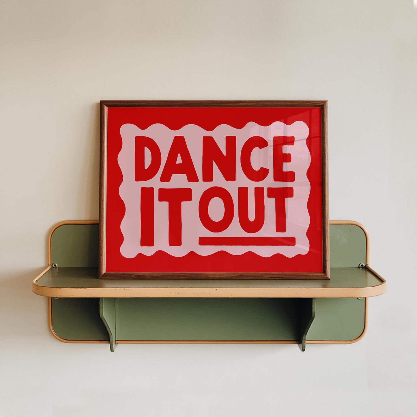 a framed sign with the text "DANCE IT OUT" in bold red letters.