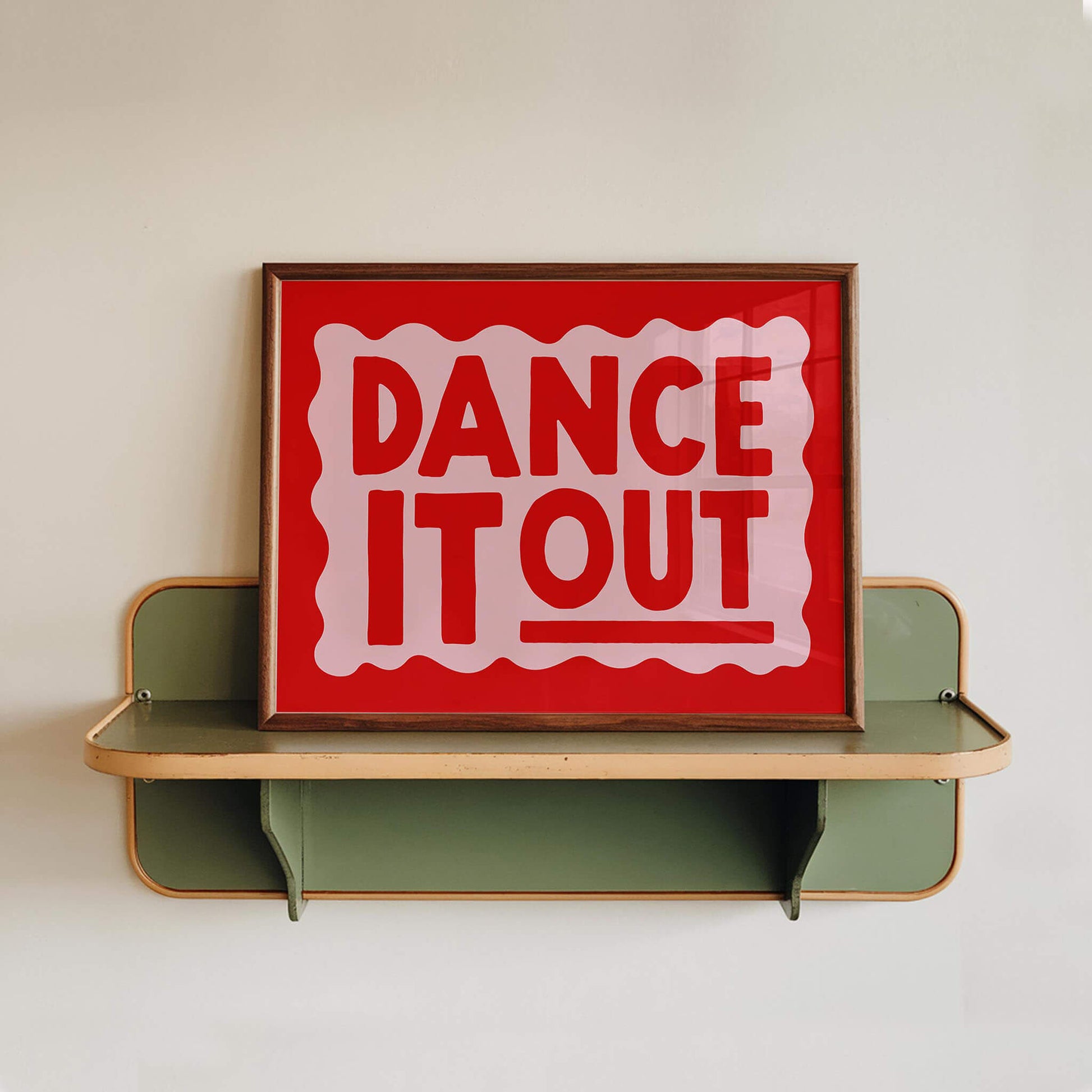 a framed sign with the text "DANCE IT OUT" in bold red letters.