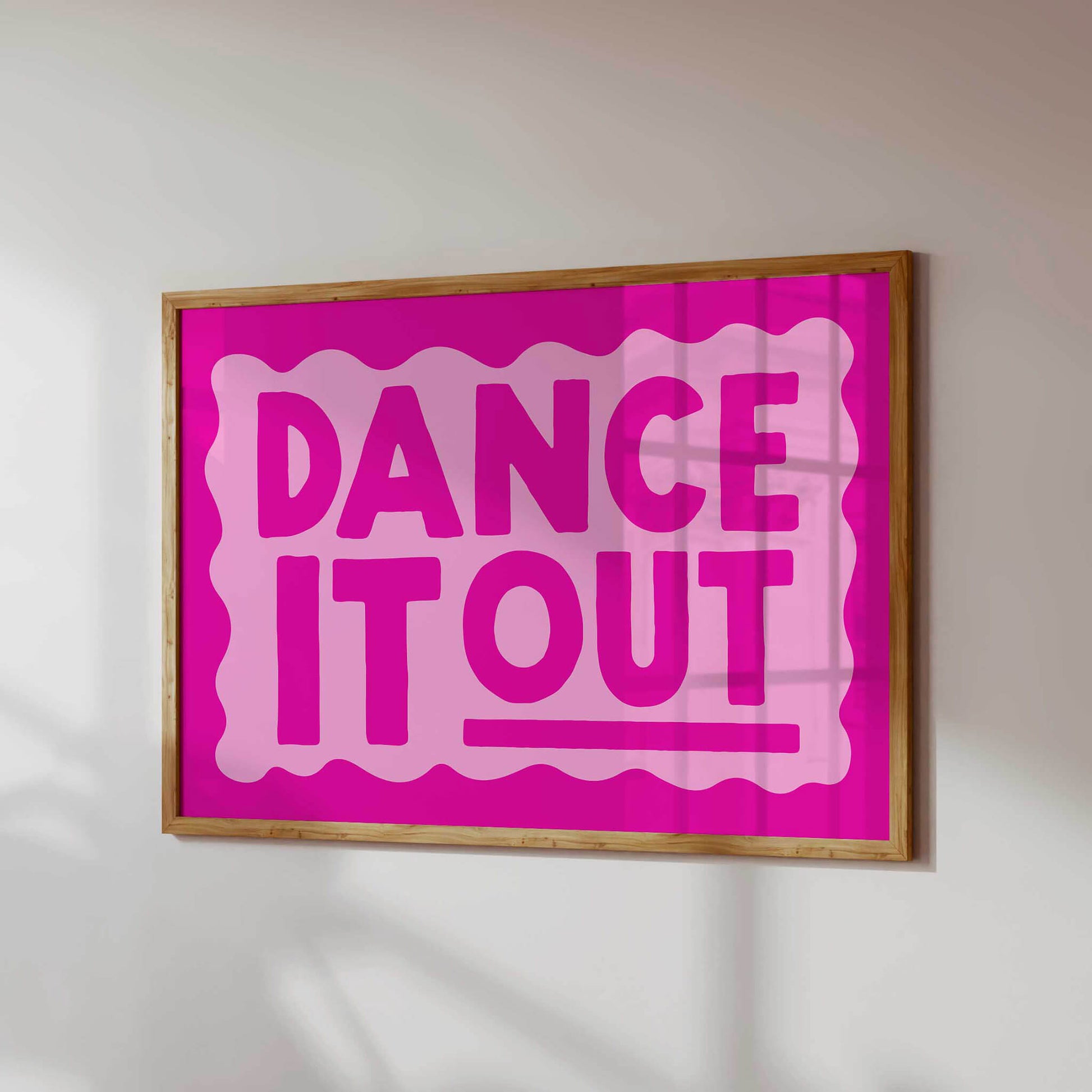 a large pink sign with the text "DANCE IT OUT" in bold, capital letters.