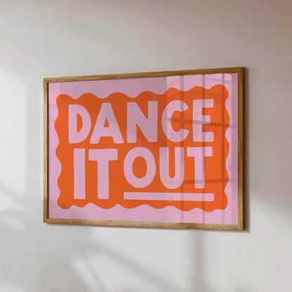 a framed poster with the text "DANCE IT OUT" in a bold, orange and pink color scheme.