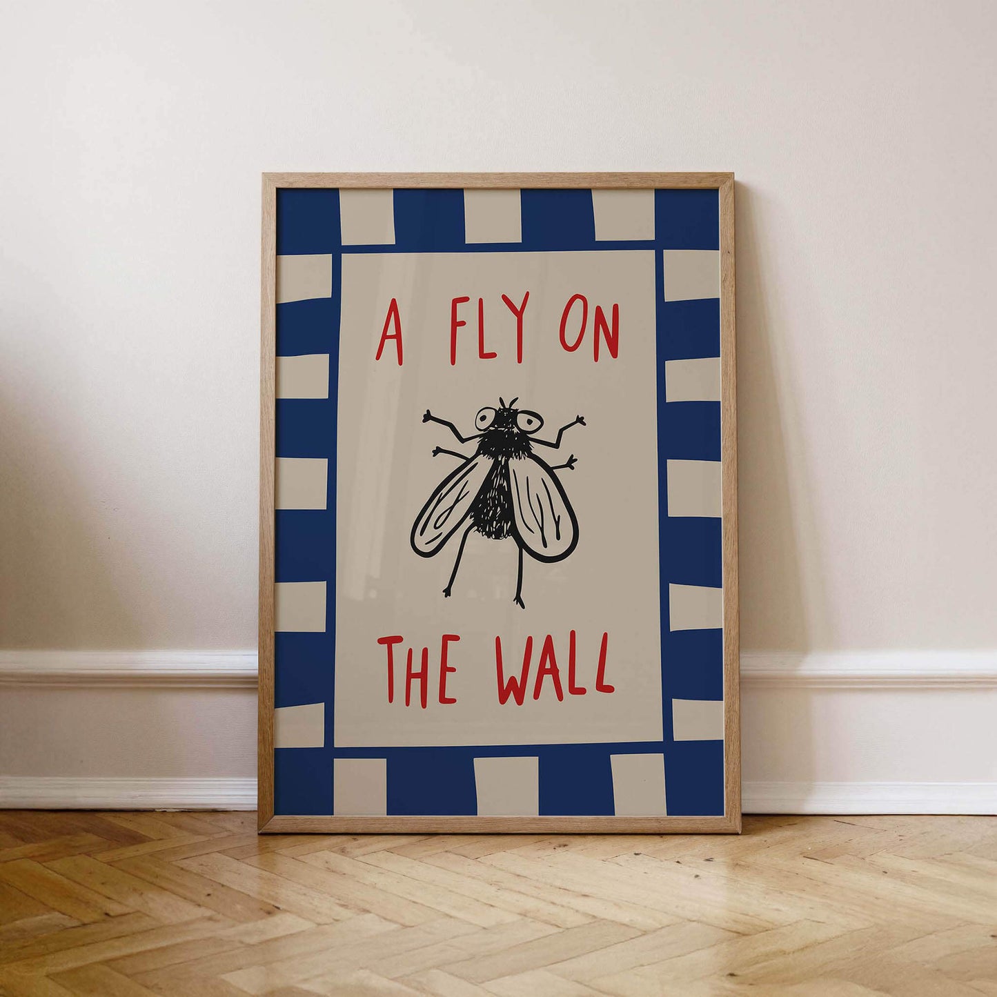 A framed poster with the text "A FLY ON THE WALL" and a black and white illustration of a fly.