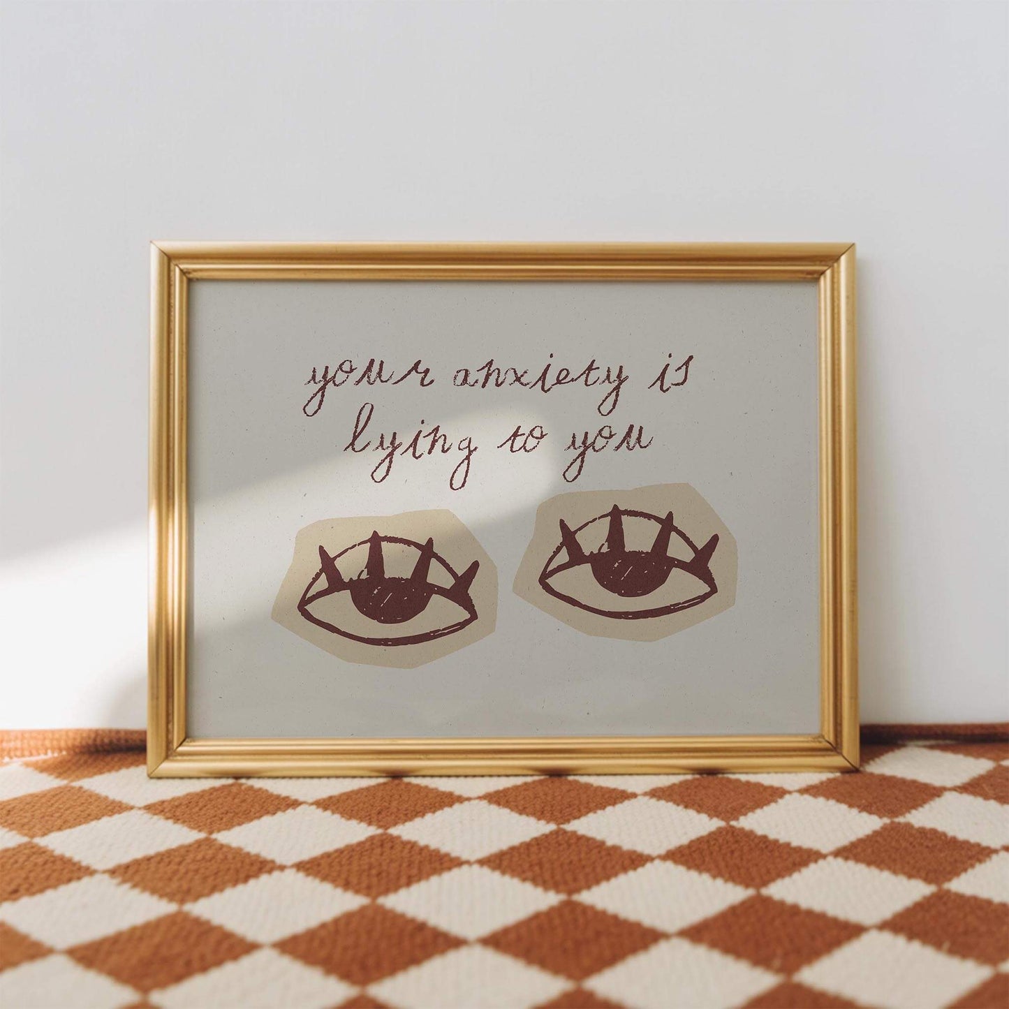a framed artwork with a text overlay that reads "your anxiety is lying to you".