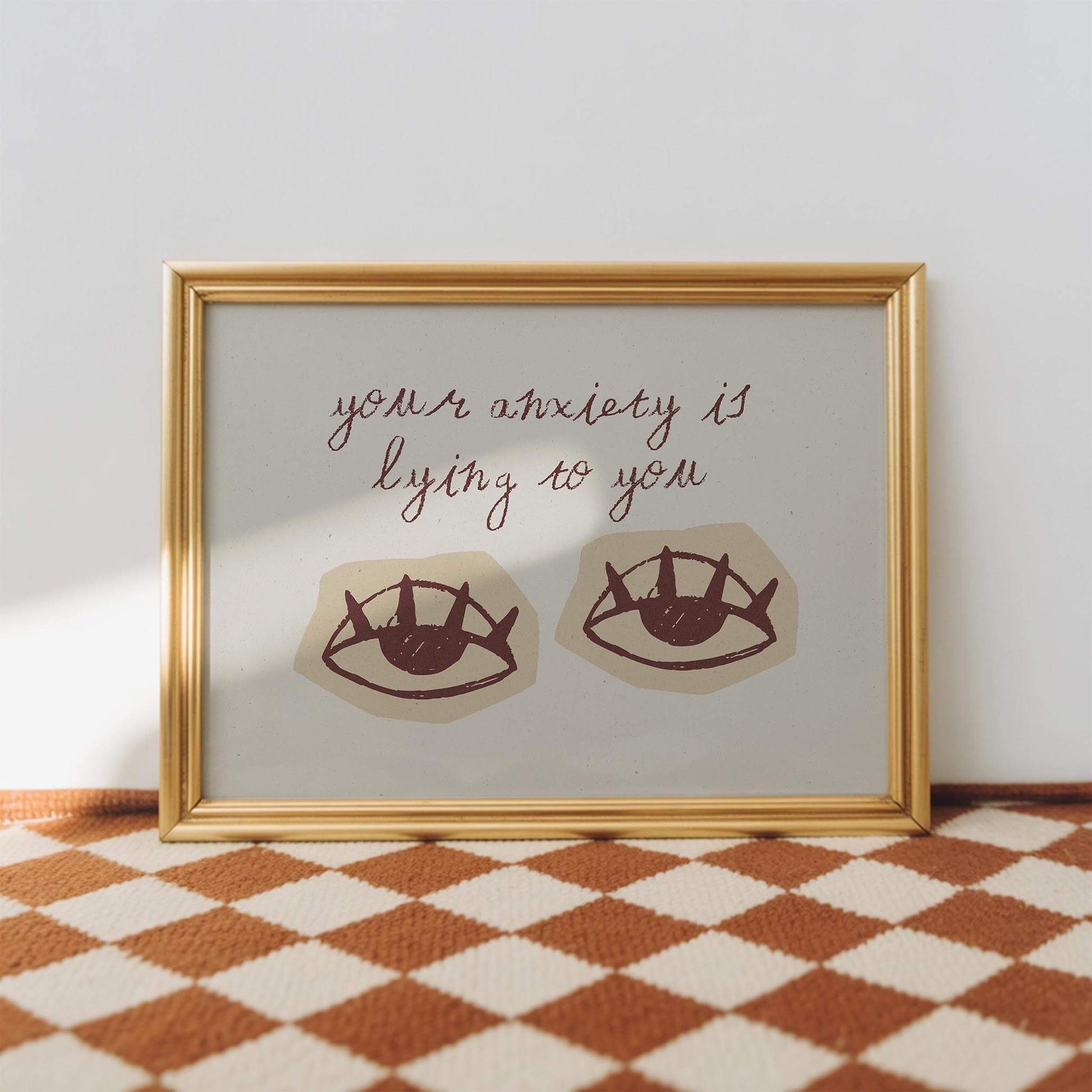 a framed artwork with a text overlay that reads "your anxiety is lying to you".