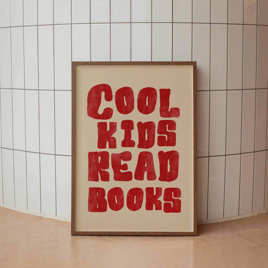 Framed poster with 'Cool kids read books' text on a tiled wall.