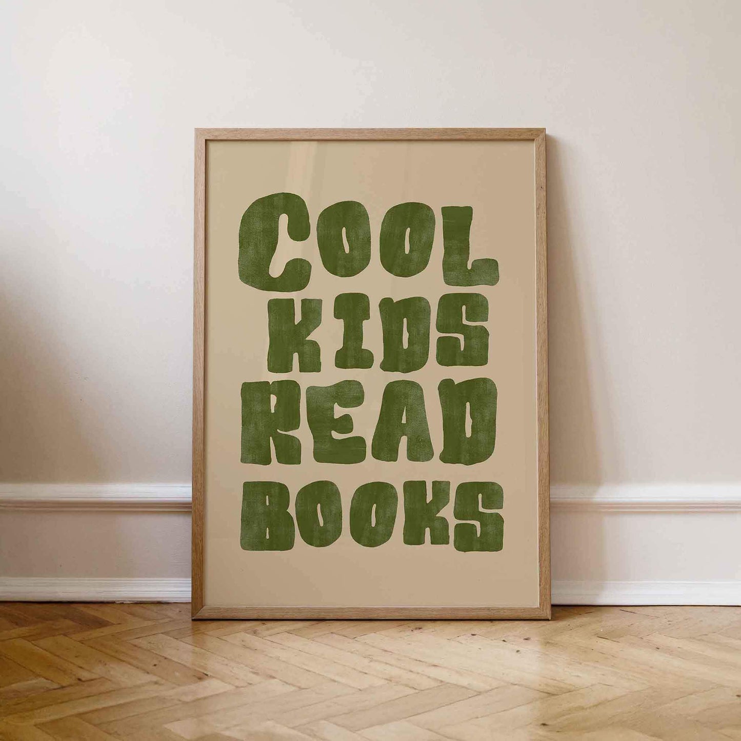 Framed poster with 'Cool kids read books' text on a beige background