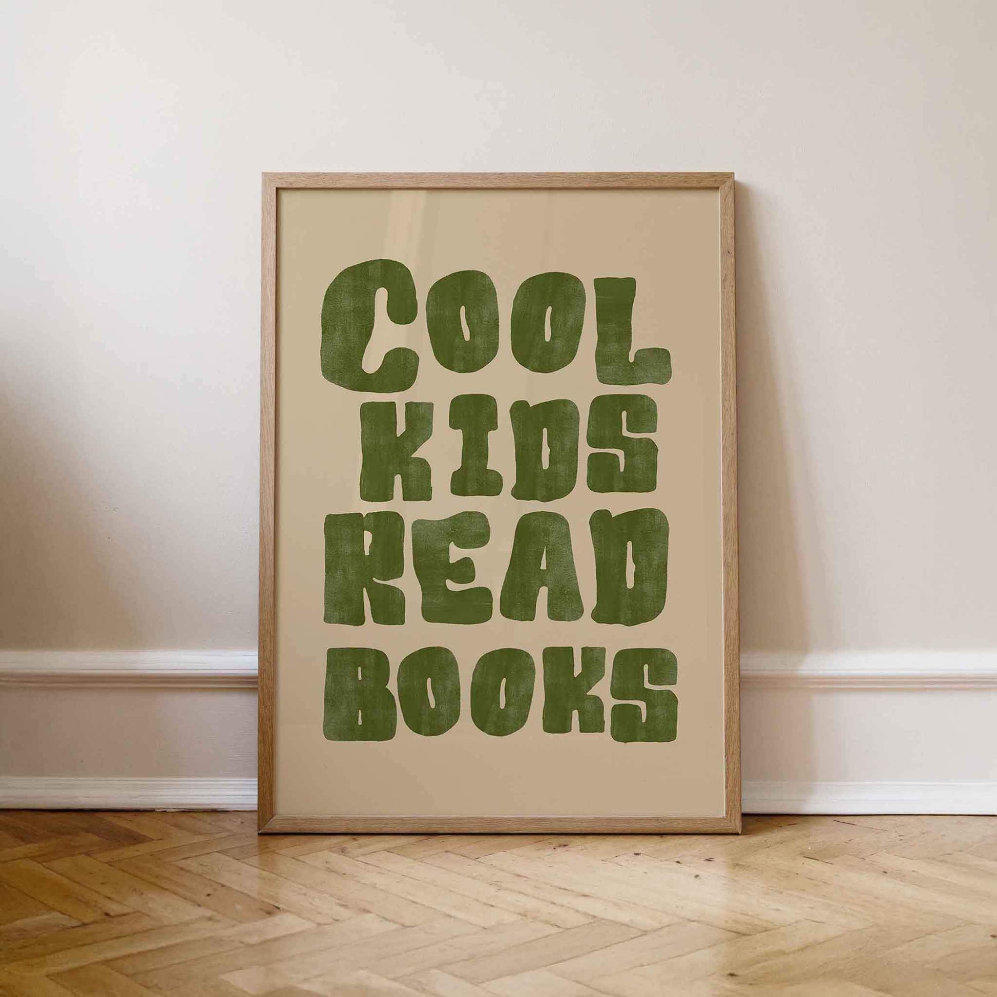 Framed poster with 'Cool kids read books' text on a beige background