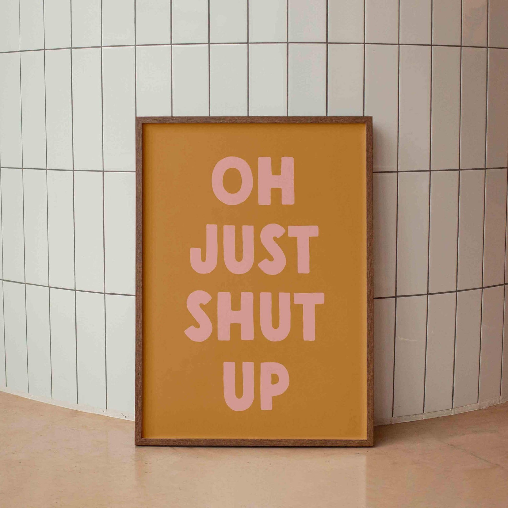 a framed poster with the text "OH JUST SHUT UP" in bold, pink letters.