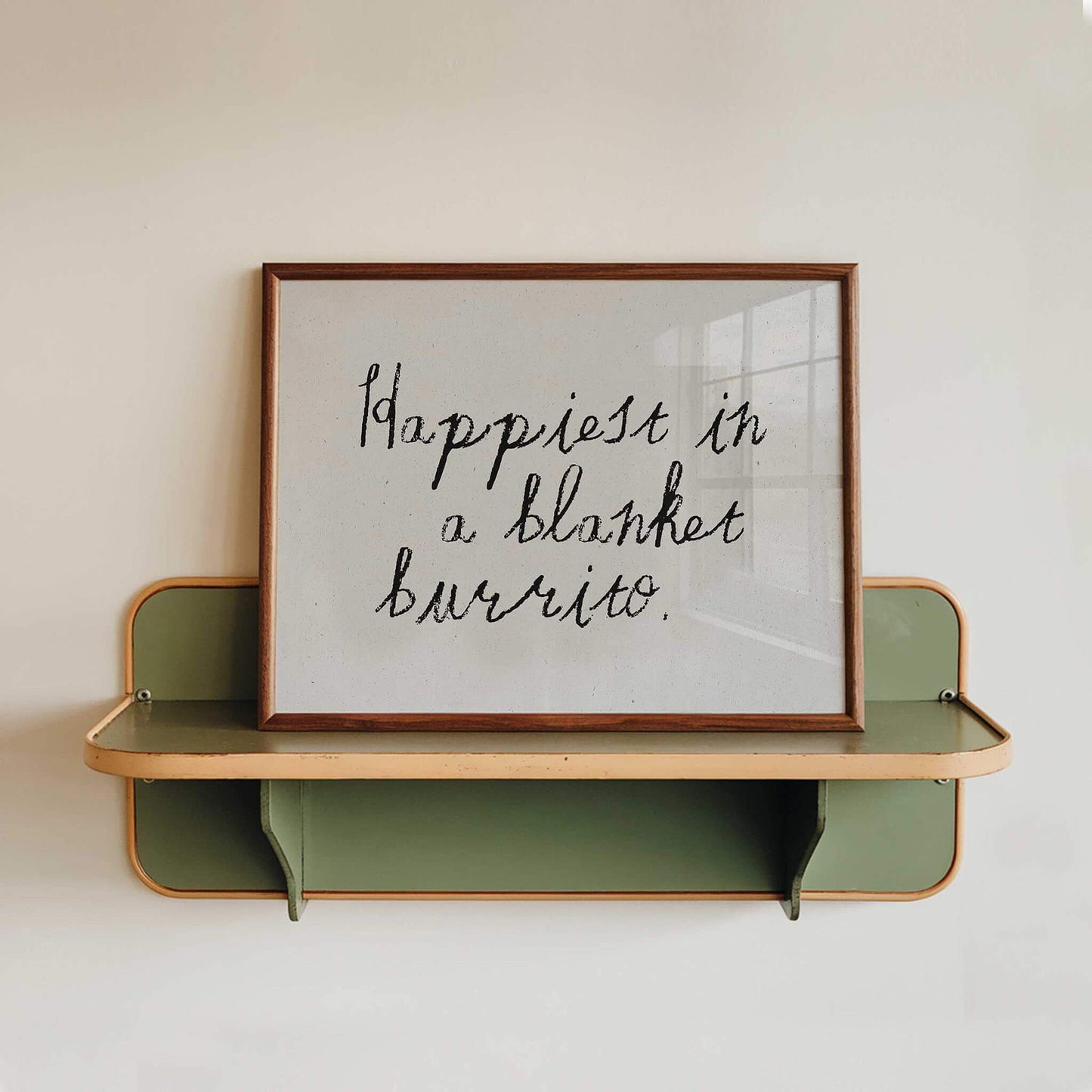 a framed quote that reads "happiest in a blanket burrito."