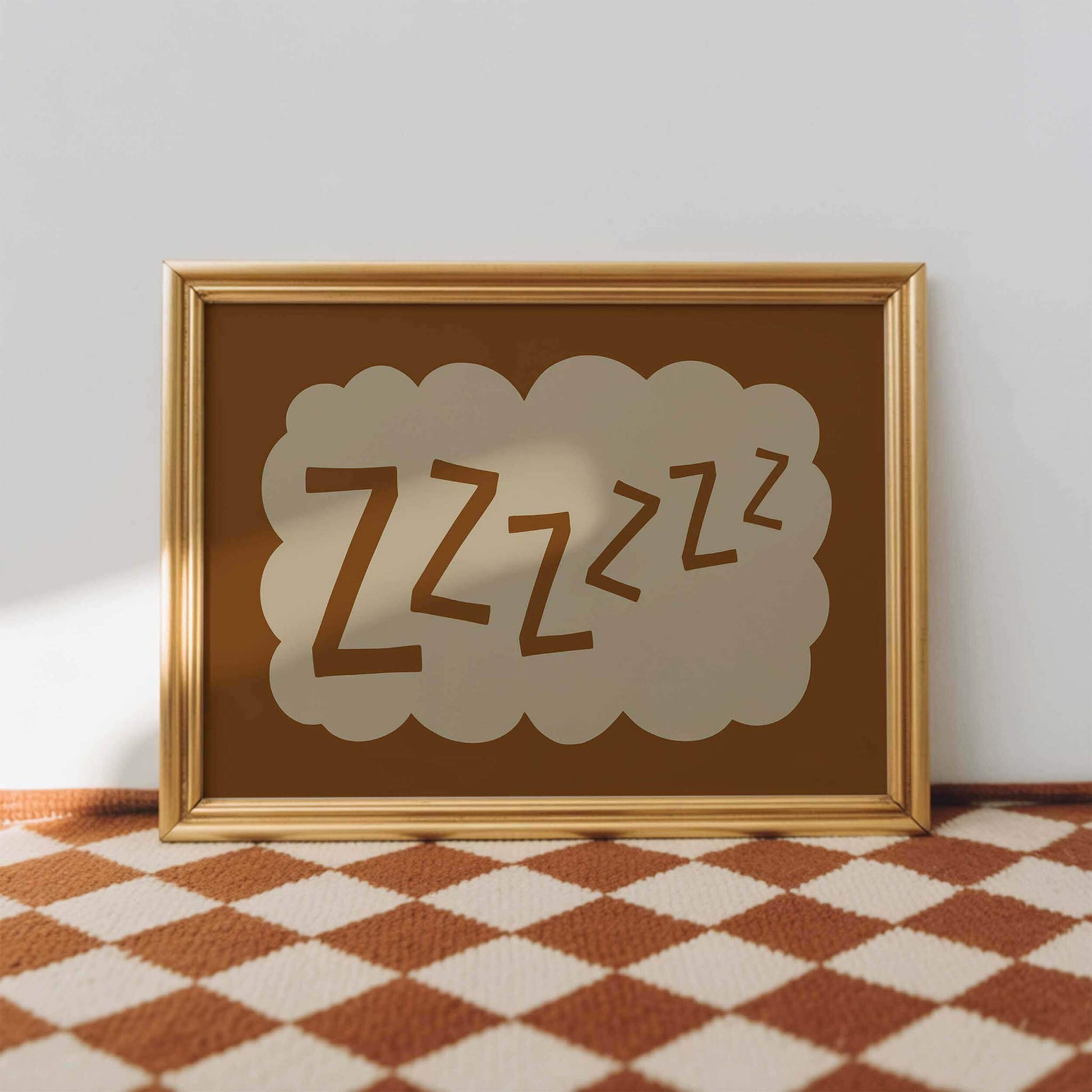 A framed picture with a brown background and a cloud-like shape containing the text "zzzzzzzz" is displayed on a checkered floor.