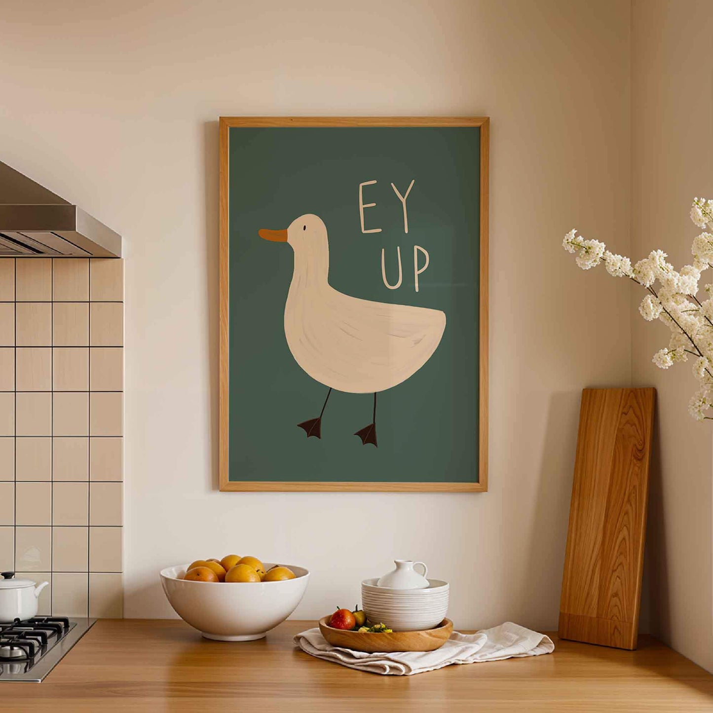 Framed colourful illustrated Yorkshire themed wall art of a duck with 'Ey Up' text in a kitchen setting